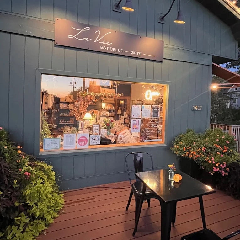  storefront with 'La Vie' sign and outdoor seating area